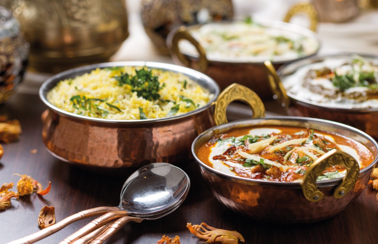 Traditional Indian Curry from Taste of India, Sheerness. Available for delivery and take away Metal bowls with various curries and rices in