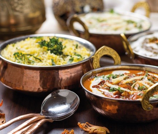 Traditional Indian Curry from Taste of India, Sheerness. Available for delivery and take away Metal bowls with various curries and rices in